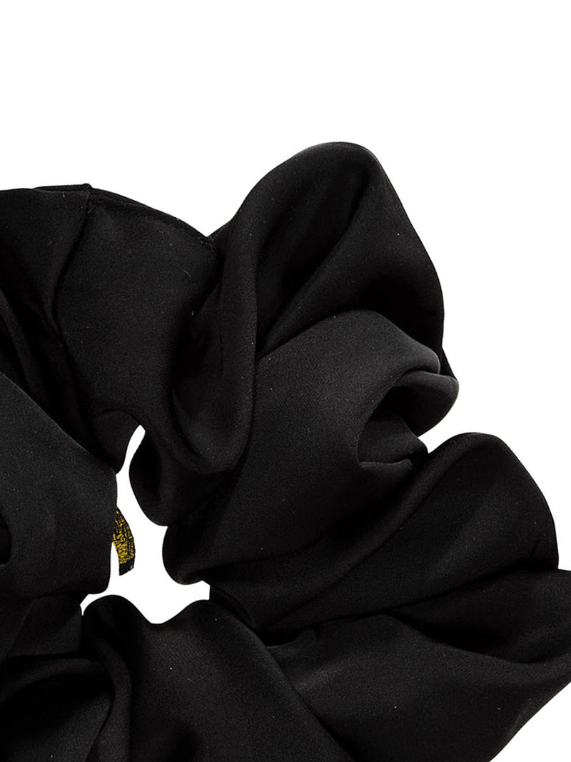 Detail of the big satin scrunchie in black against white backround