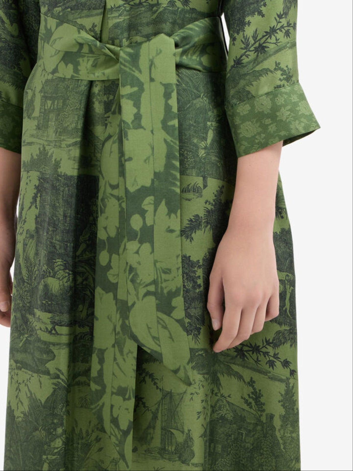 Green patterned dress with a belt on a white background