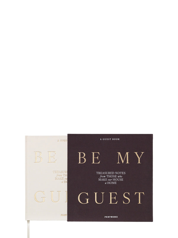 Off-white guestbook titled 'Be My Guest' pulled out from its darker cover on a white background