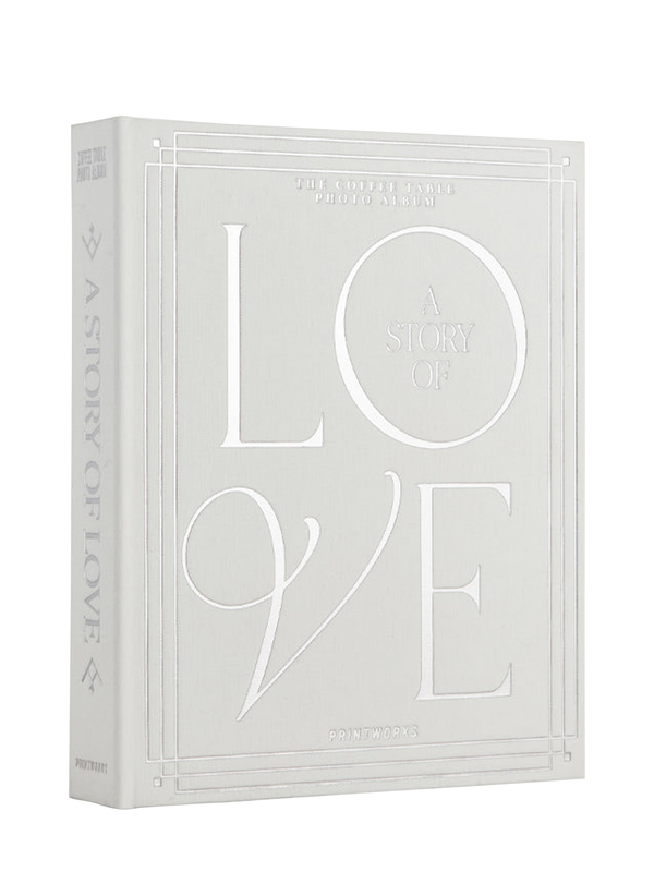 A white off-white photo album with silver foiled text titled 'A Story of Love' on the cover, designed for holding wedding photos.