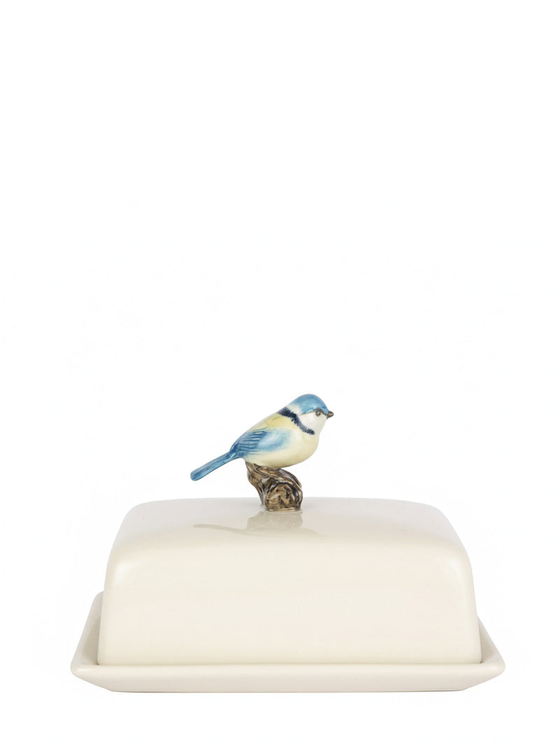 Butter dish with a ceramic bird decoration on the top