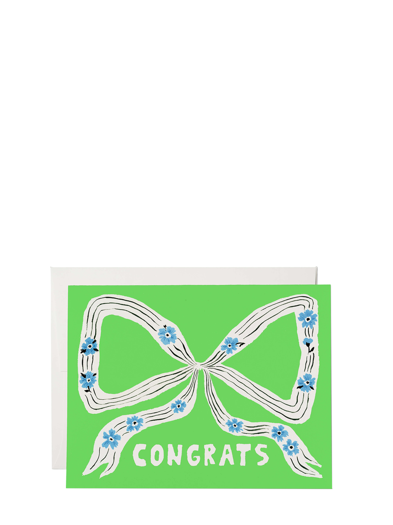 Greeting card with a green background featuring a white ribbon with blue flowers and the word 'CONGRATS' in bold letters. It comes with a white envelope.