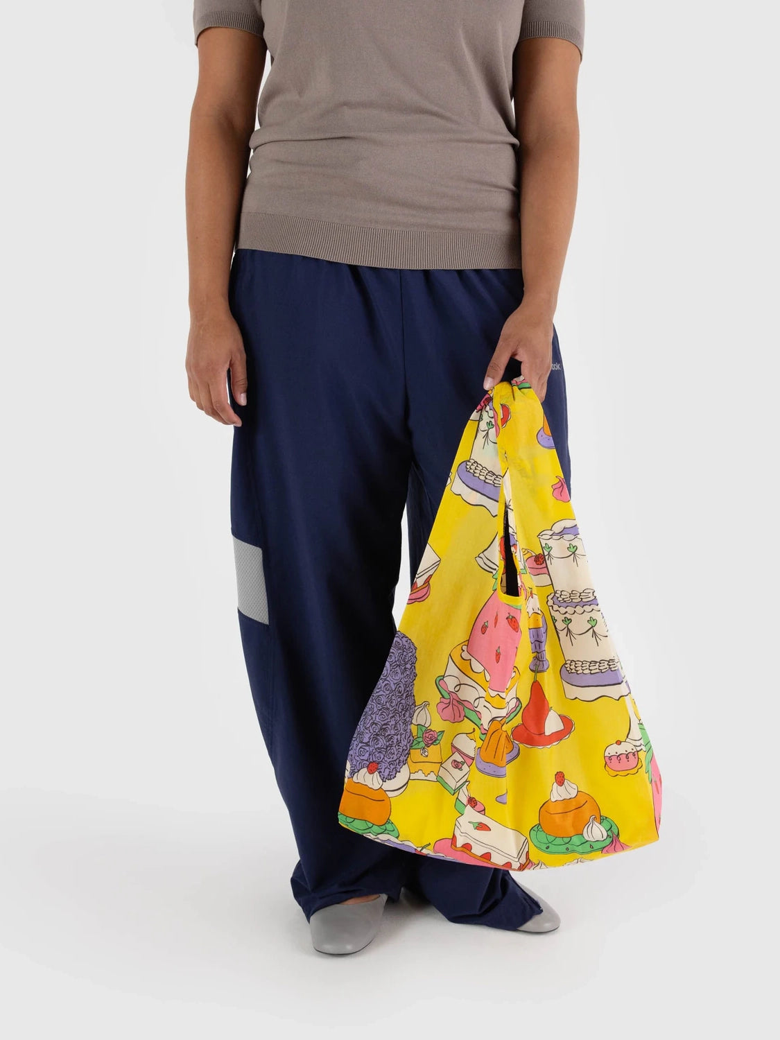 Person holding a colorful bag with a white background