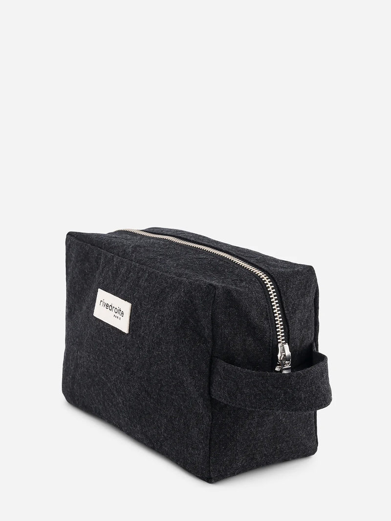A dark charcoal black cotton canvas zippered pouch with a small white brand label reading 'rivedroite paris' on the front, set against a plain light gray background.