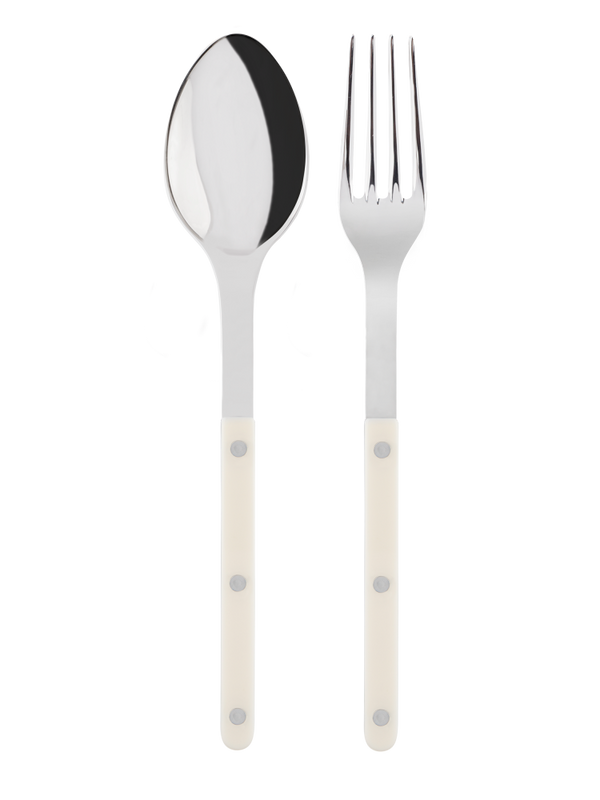 A serving fork and spoon with white handles