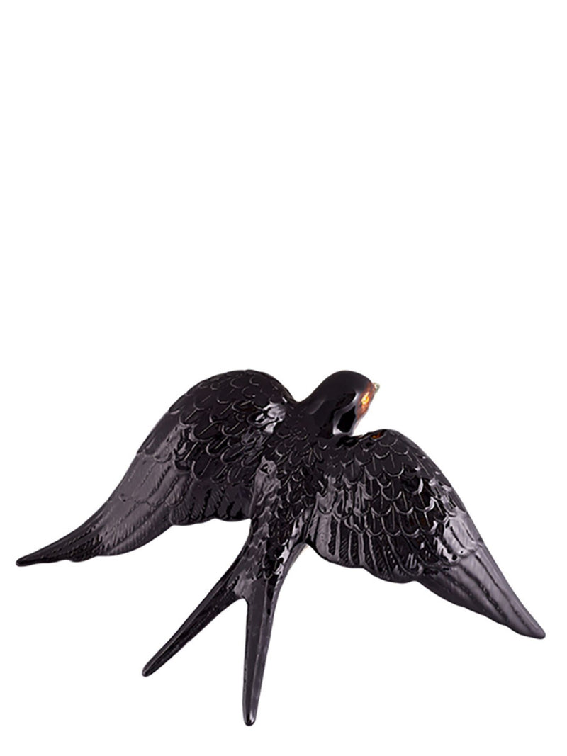 Black swallow ceramic figurine on a white background