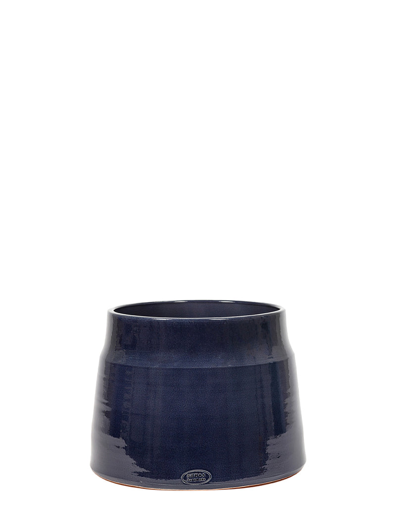 A dark navy blue glazed ceramic planter pot with a subtle conical shape and a small circular logo near the base, set against a solid white background.