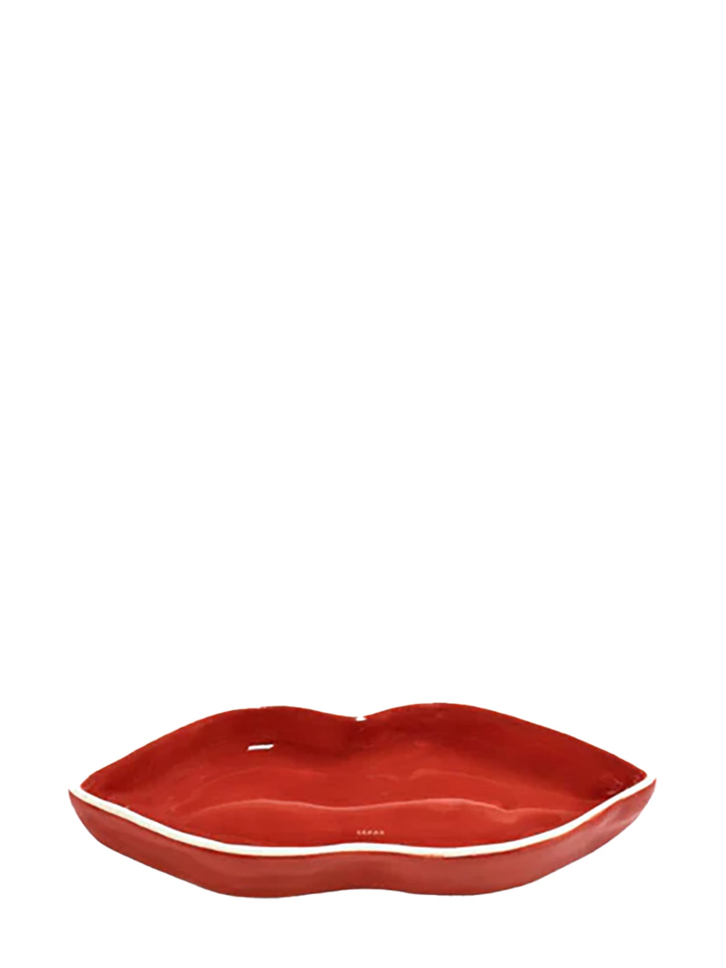 A red ceramic serving dish shaped like lips with a white outline on the rim, displayed against a white background.