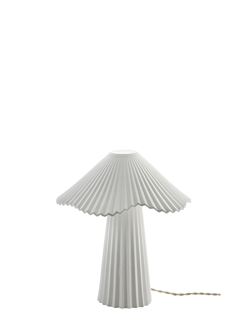 A white pleated contemporary designer table lamp with a conical shade and matching pleated base, shown against a plain white background with its fabric covered power cord visible on the right.