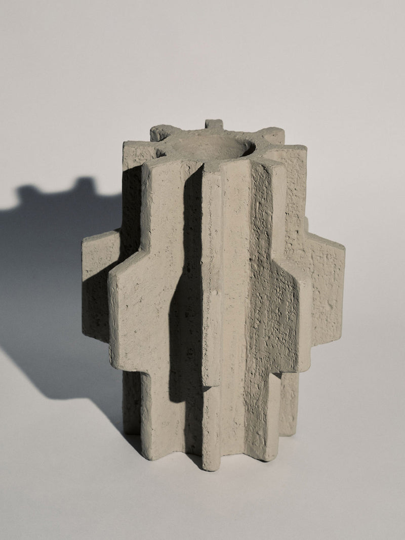 Concrete block with geometric design on a light gray background