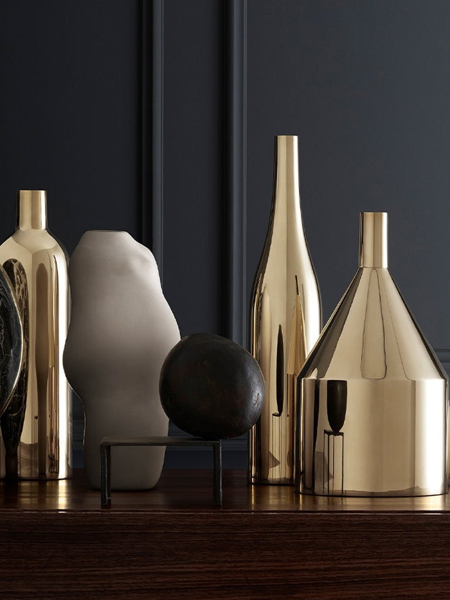 Set of decorative vases on a dark surface with a dark background