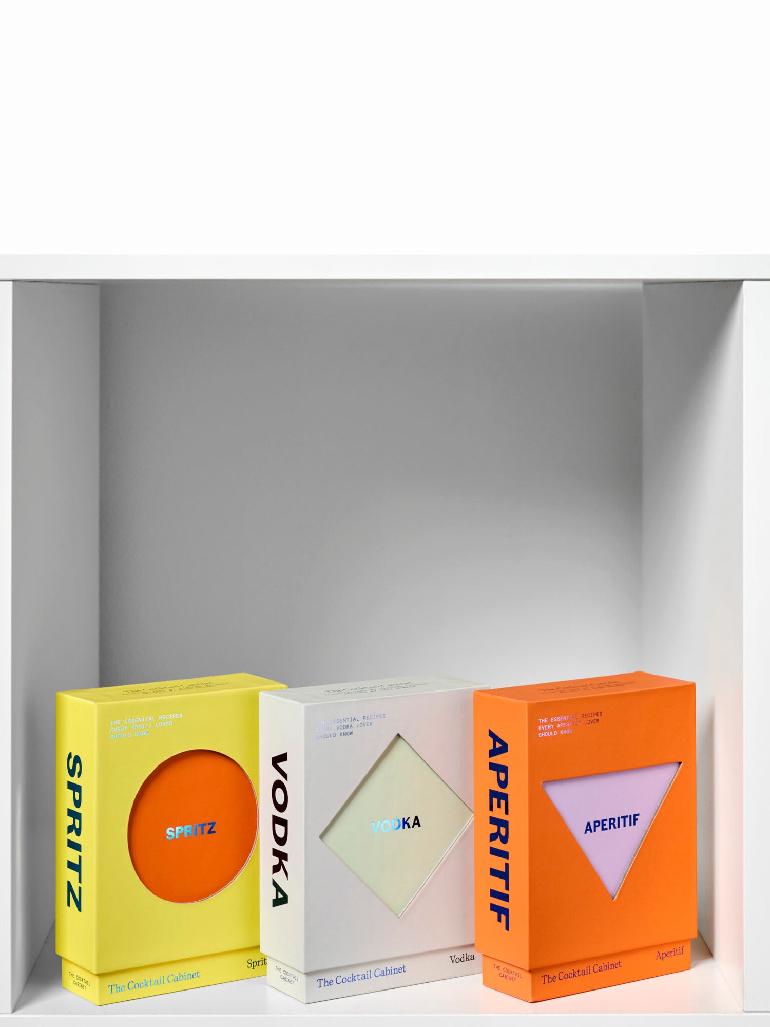 Three boxes labeled 'Spritz', 'Vodka', and 'Aperitif' on a white shelf.