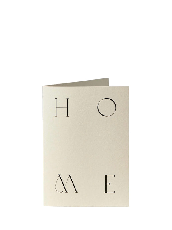 Beige greeting card with 'HOME' printed on it against a white background