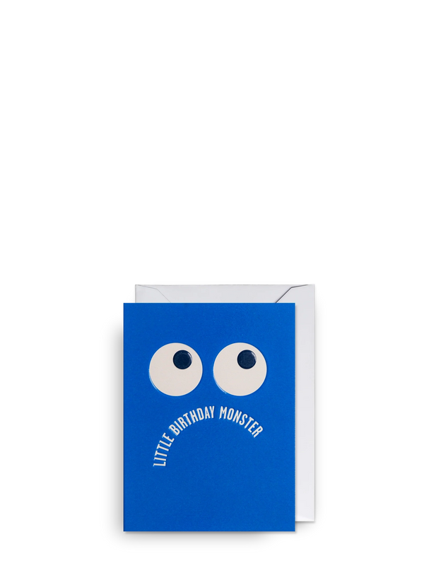 Blue greeting card with white eyes and text 'Little Birthday Monster' on a white background