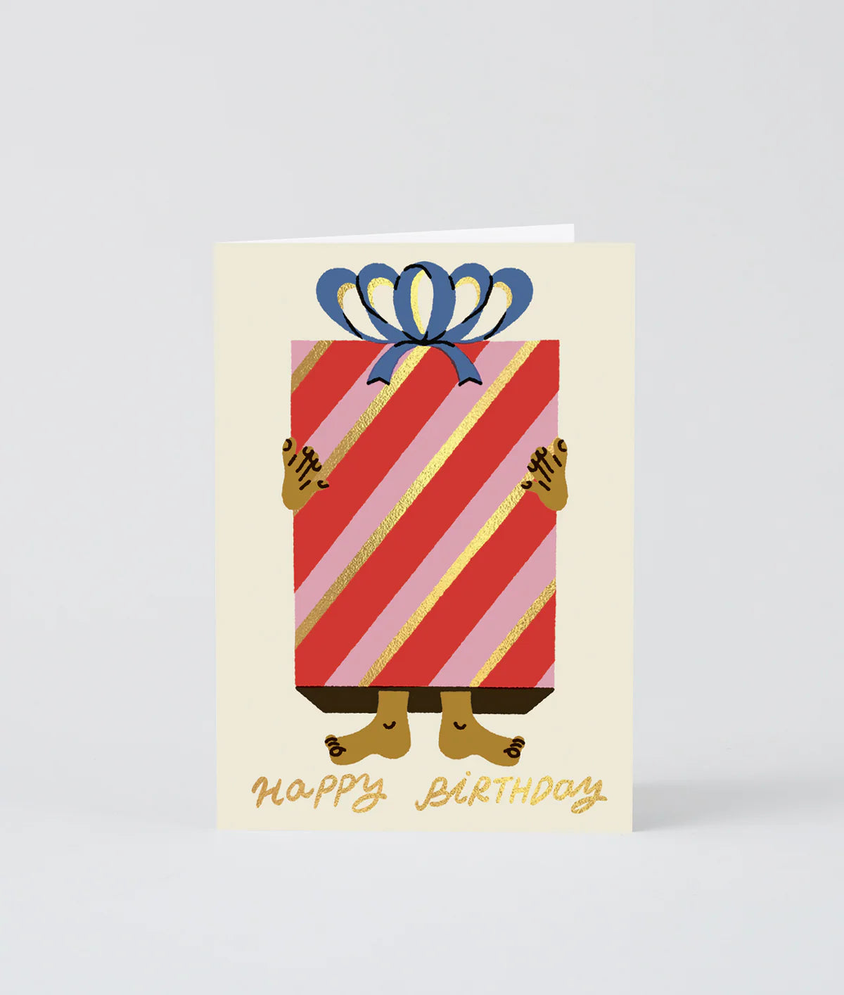 Birthday card with a striped gift box and feet holding it, on a light gray background