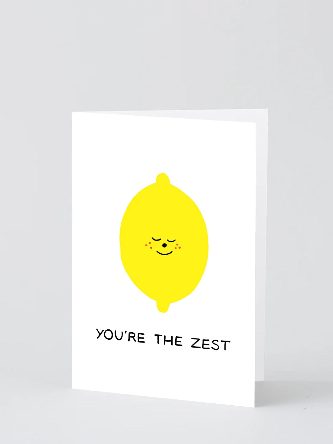 A greeting card with a illustration of a smiling lemon and the text 'YOU'RE THE ZEST'.