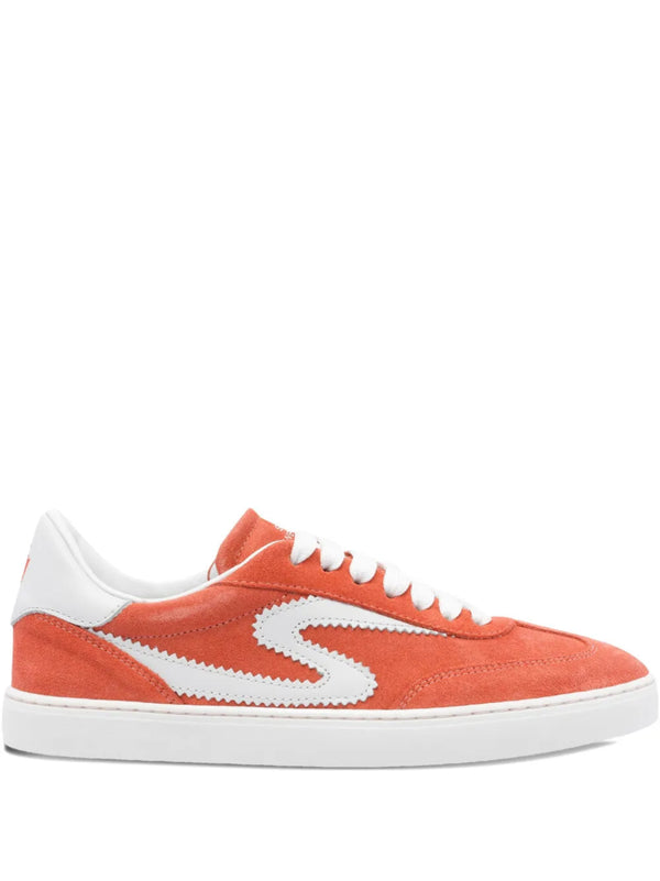Orange sneaker with white laces and sole on a white background