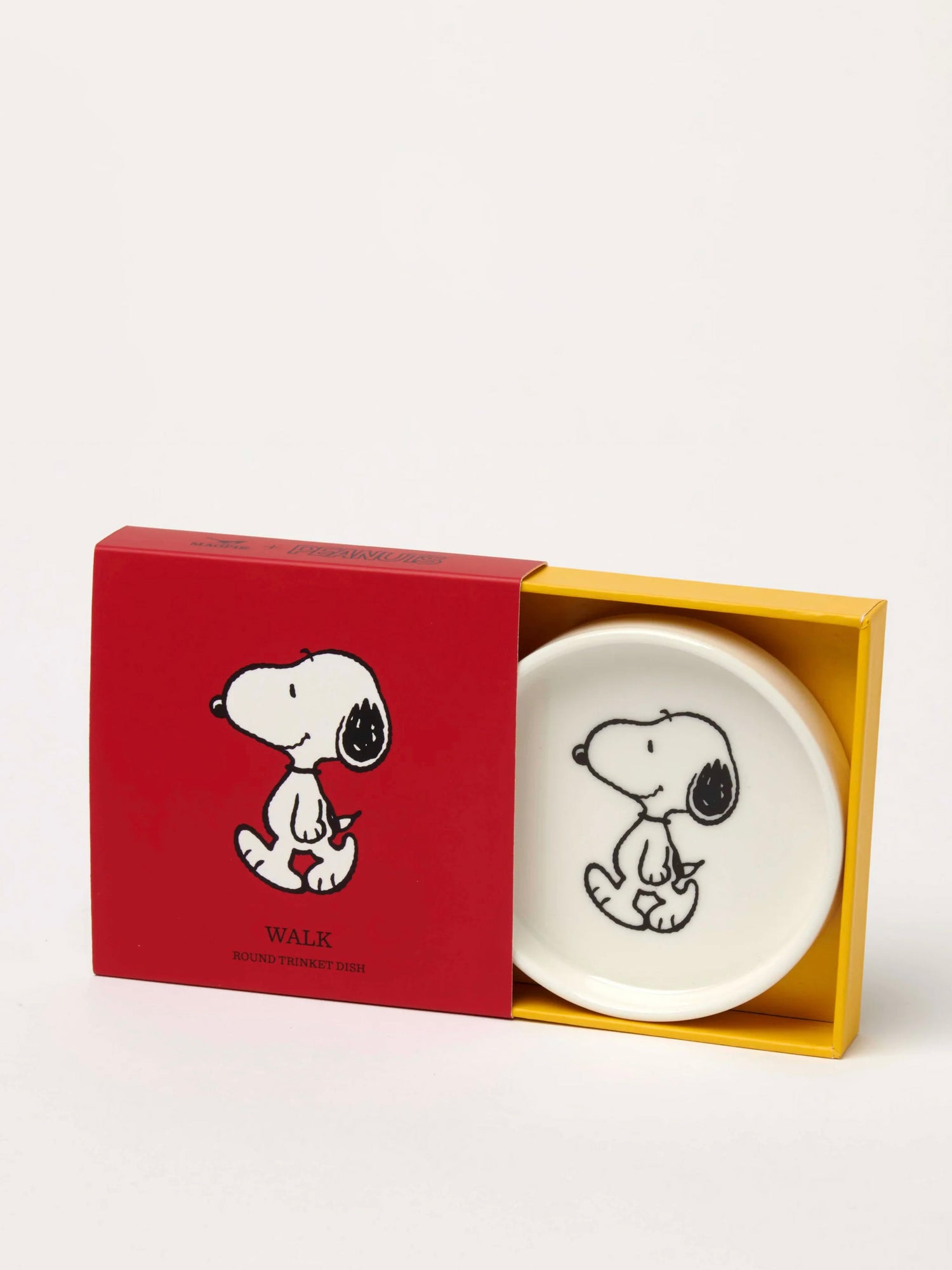 White dish with black and white Snoopy dog illustration in a red box with a yellow interior