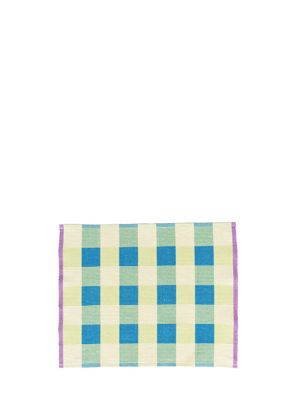 A square panama weave placemat with a checkered pattern in turquoise blue, light green, and cream, finished with a purple border, shown on a plain white background.