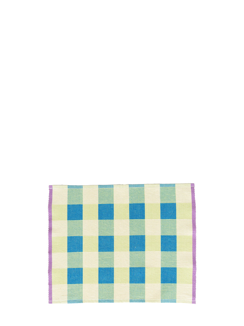 A square panama weave placemat with a checkered pattern in turquoise blue, light green, and cream, finished with a purple border, shown on a plain white background.