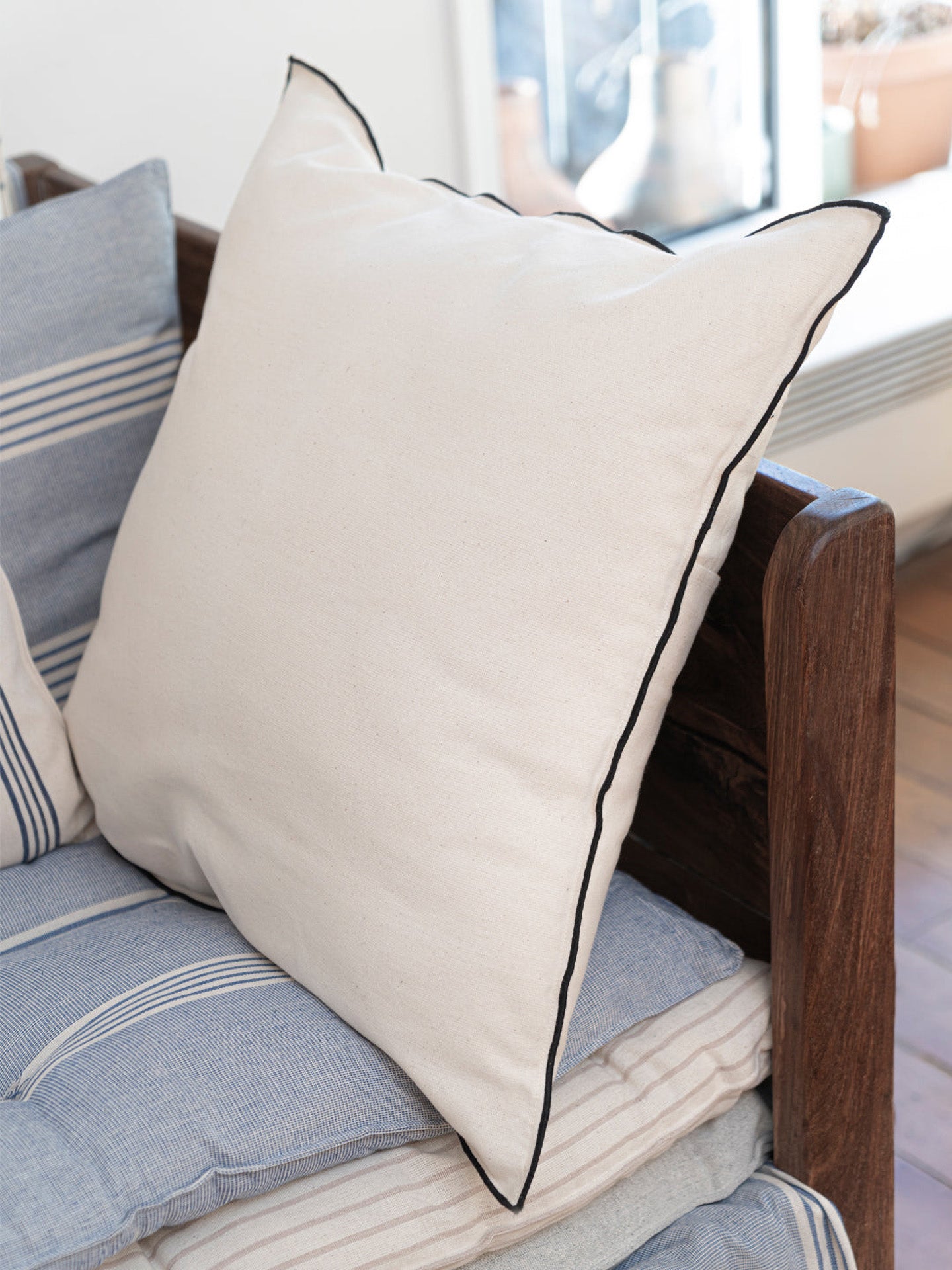 Cushion no 1 solid ivory w/black edges, 50 x 50 cm