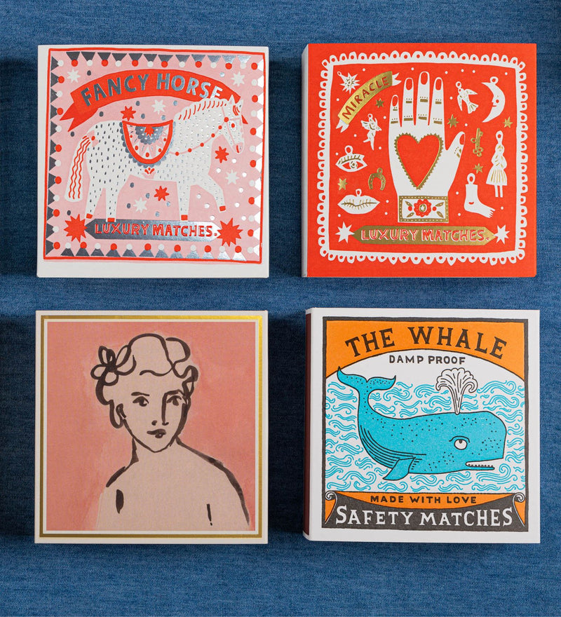 Four matchbox designs on a blue background