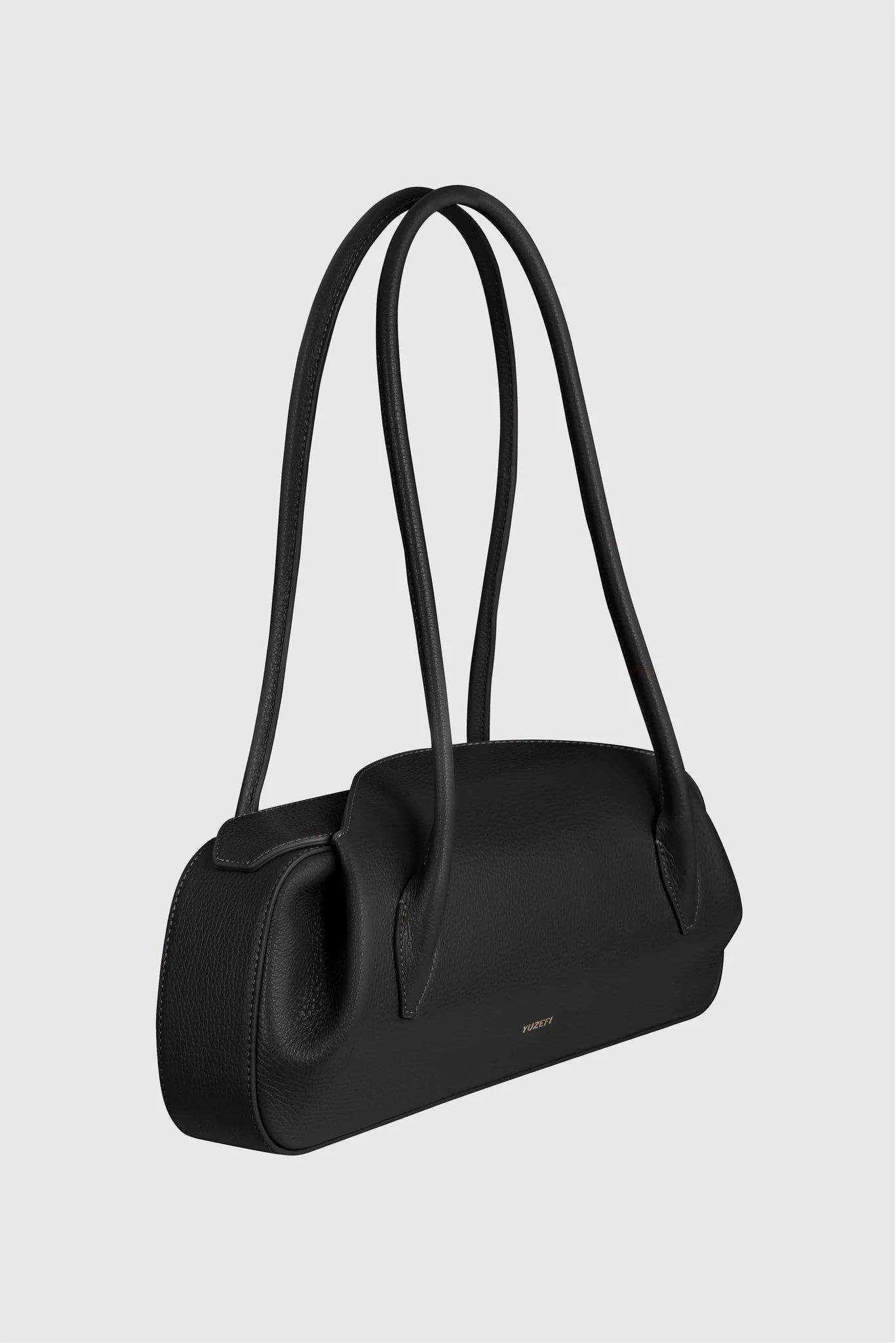 Yuzefi's lack handbag with shoulder straps on a light gray background