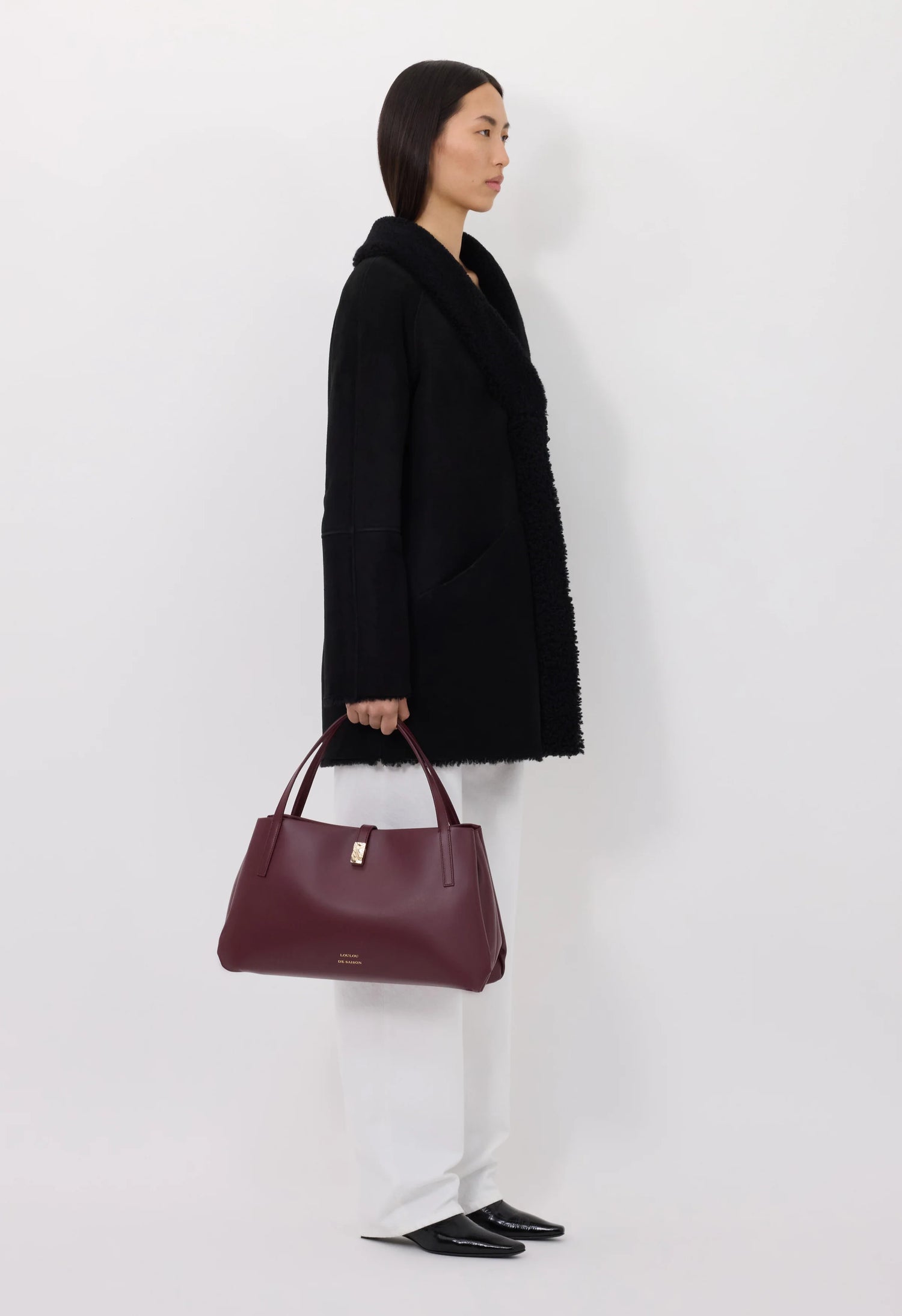 Woman wearing a black shearling coat