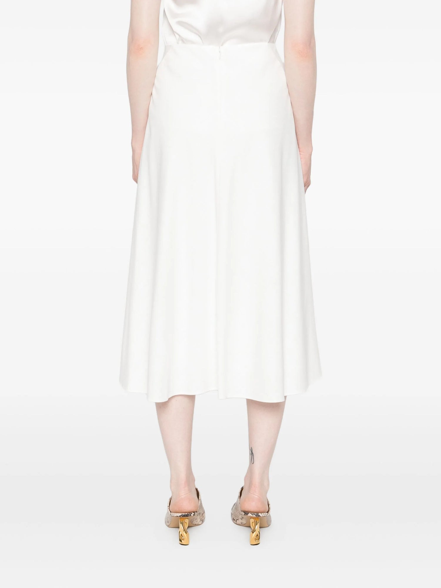 White skirt worn by a model on a white background