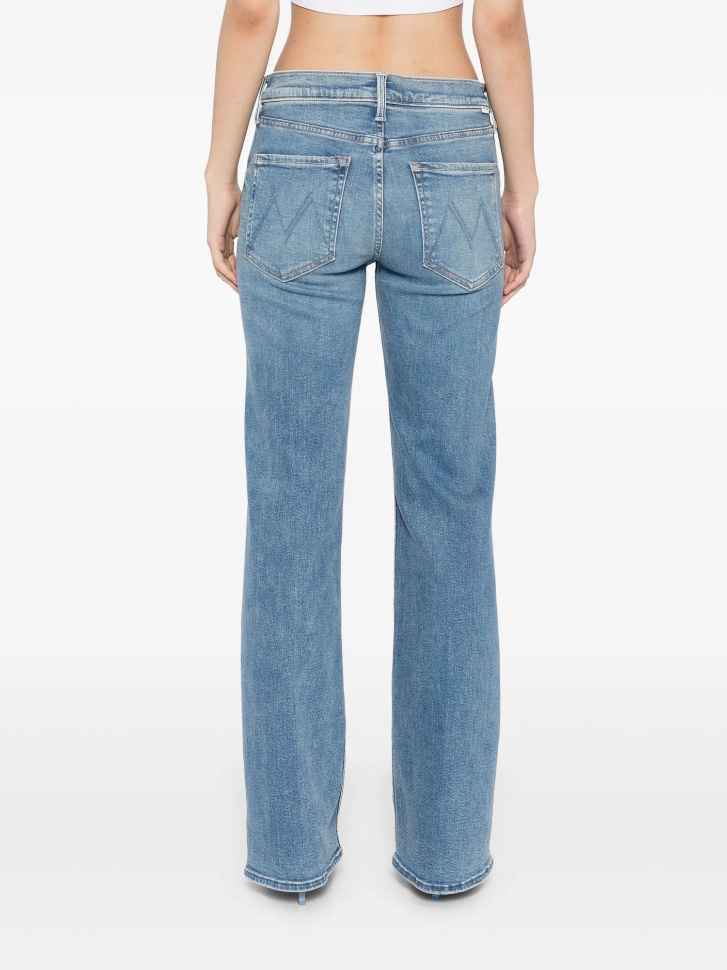 Light blue jeans worn by a person on a white background