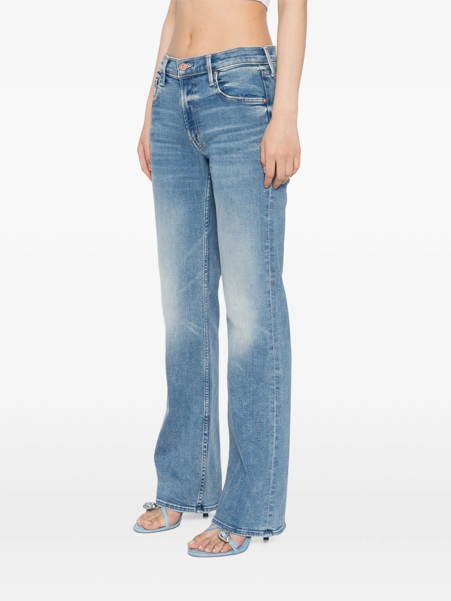 Light blue jeans worn by a person on a white background