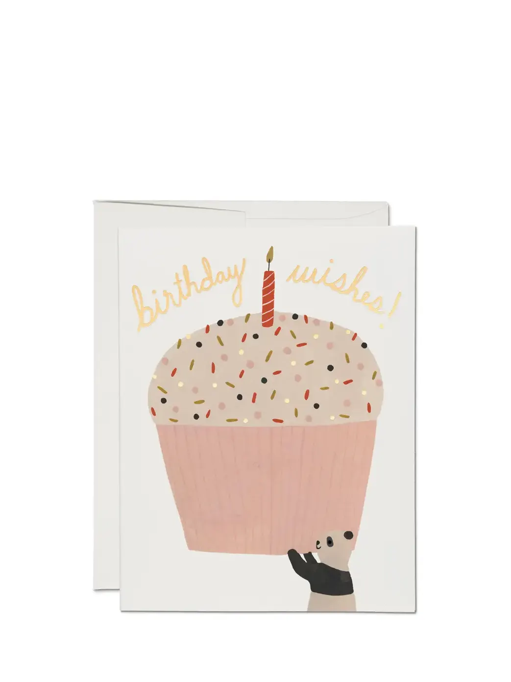 A birthday card with an illustration of a cupcake with sprinkles and a candle, with the text 'birthday wishes!' on top. The card is pink and there is a white envelope included.
