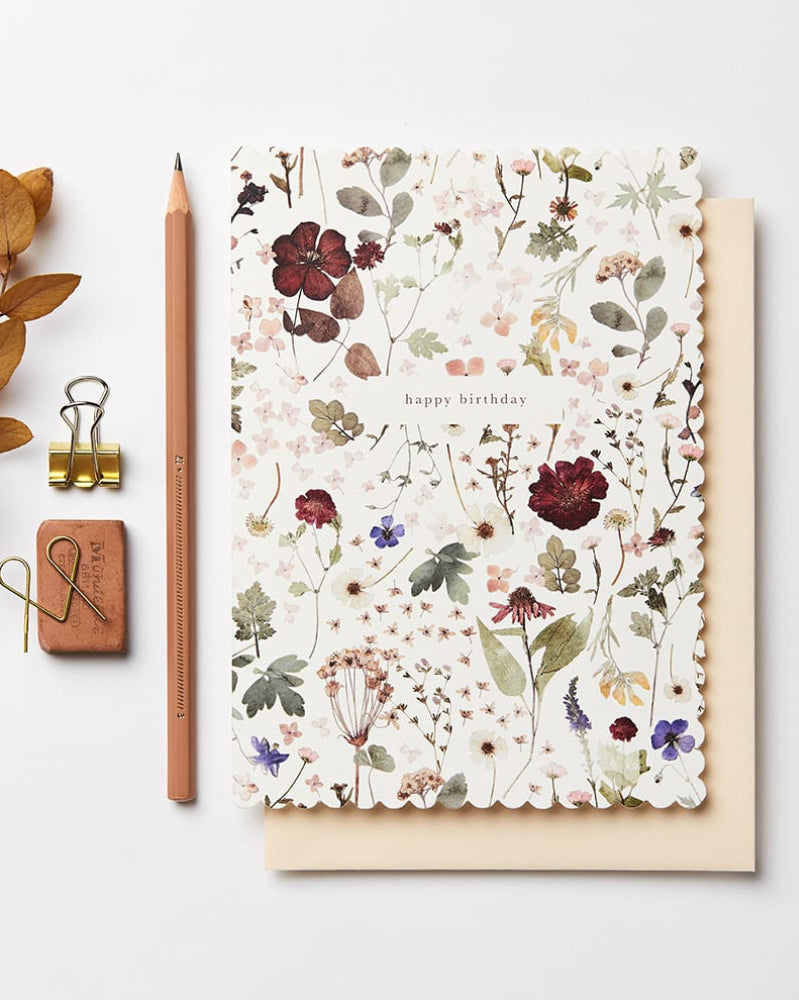 Floral-patterned card with 'happy birthday' text on a white background