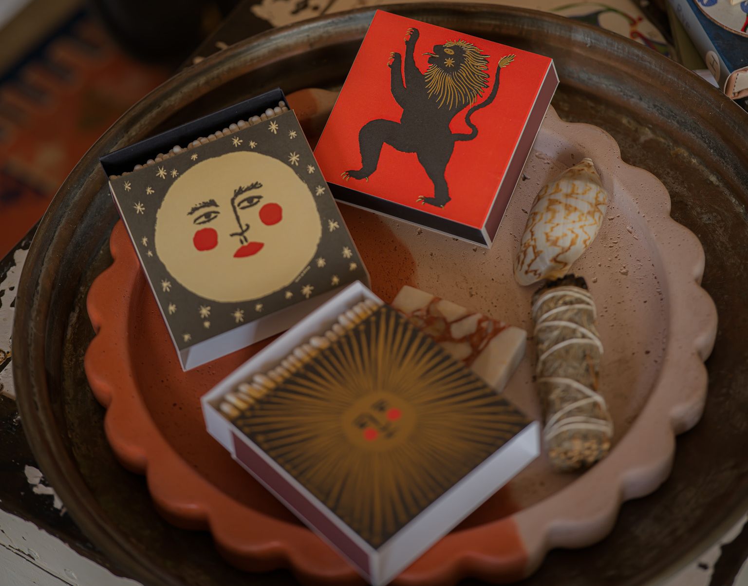 Three small boxes with decorative designs on a textured surface