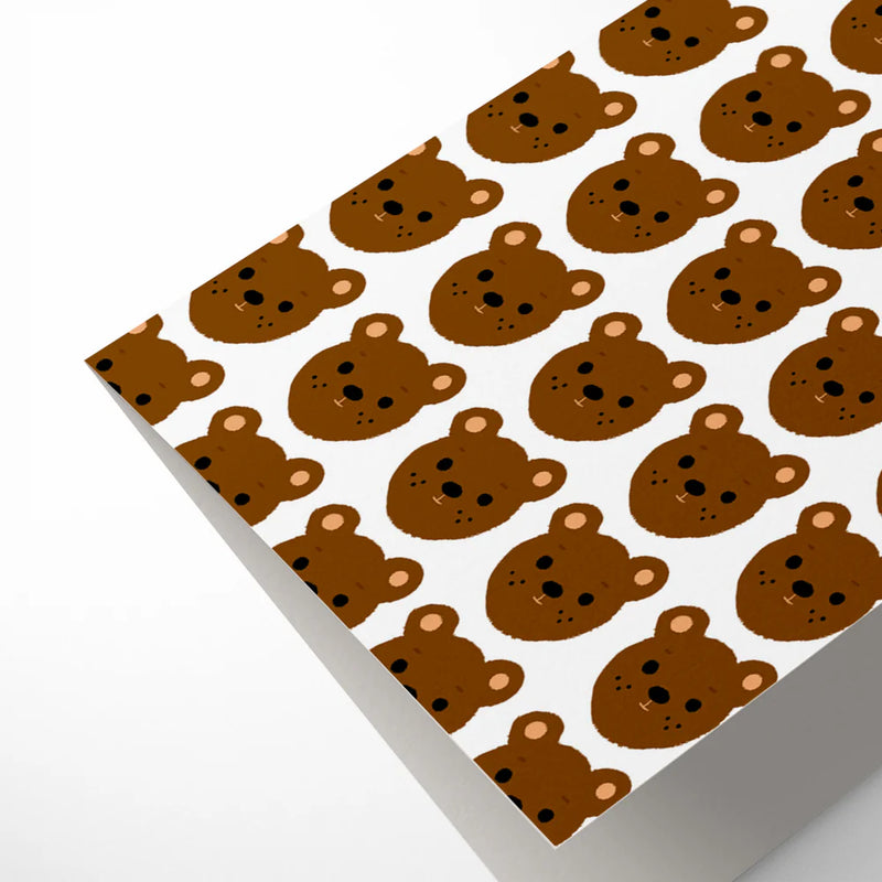 Greeting card with brown bear pattern on white background