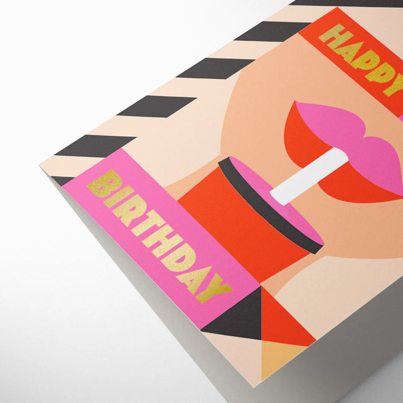 Birthday card with a colorful design of a cake and candles on a black and white striped background.