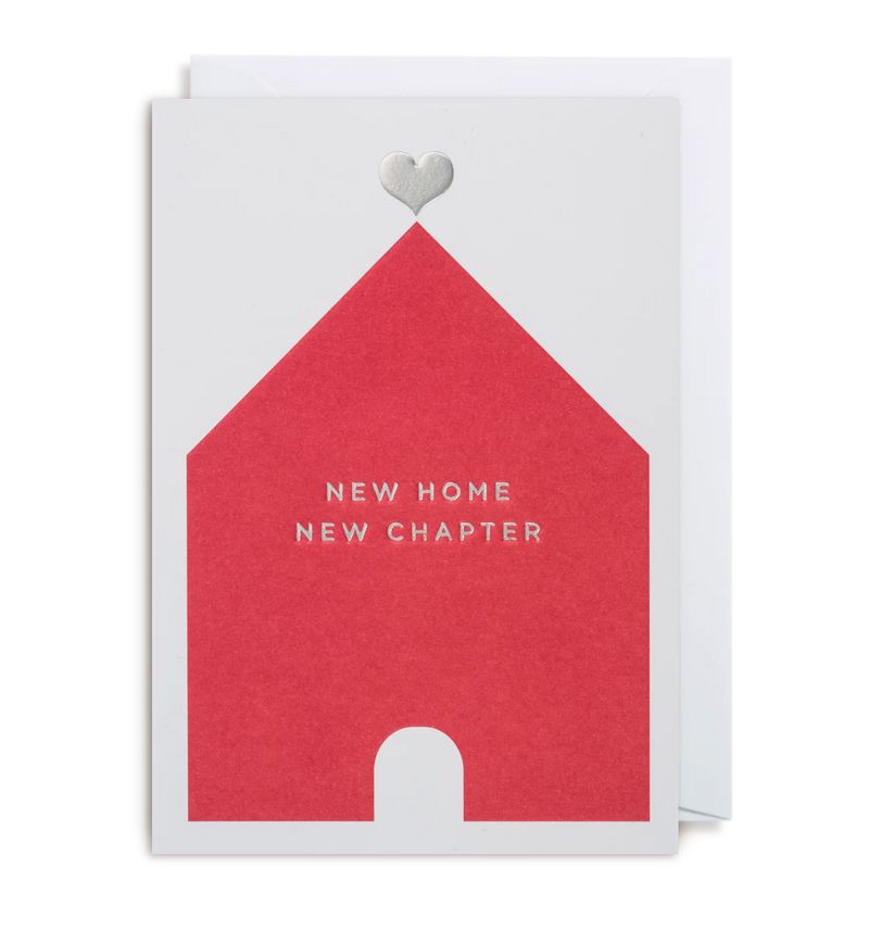 A greeting card with a red house illustration and the text 'NEW HOME NEW CHAPTER' on it, accompanied by a white envelope.