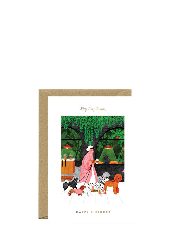 Greeting card with illustration of a person walking dogs in a park, with 'Happy Birthday' text.