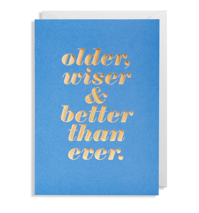 A blue greeting card with the text 'older, wiser & better than ever.' in gold foil. Includes a matching envelope.