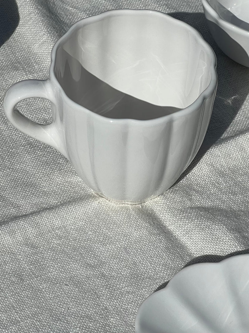 White ceramic cup on a textured gray surface