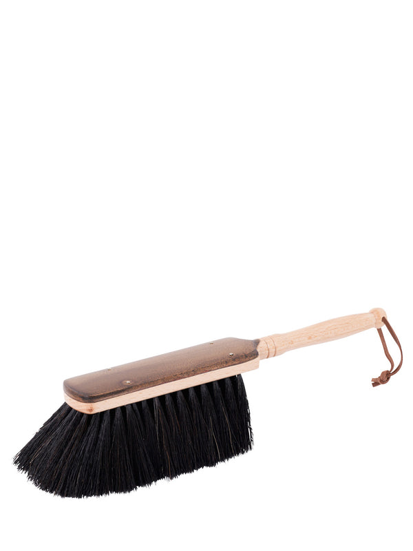 A waxed beechwood hand brush with black horsehair bristles and a wooden handle.