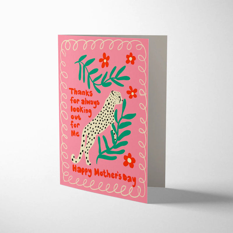 Greeting card with a leopard illustration and floral elements on a pink background