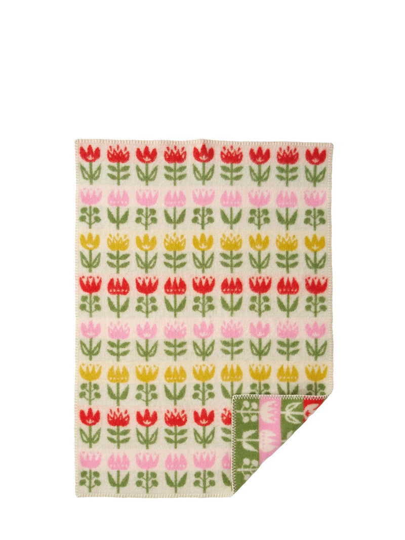 Floral patterned fabric with red, pink, and yellow tulips on a white background