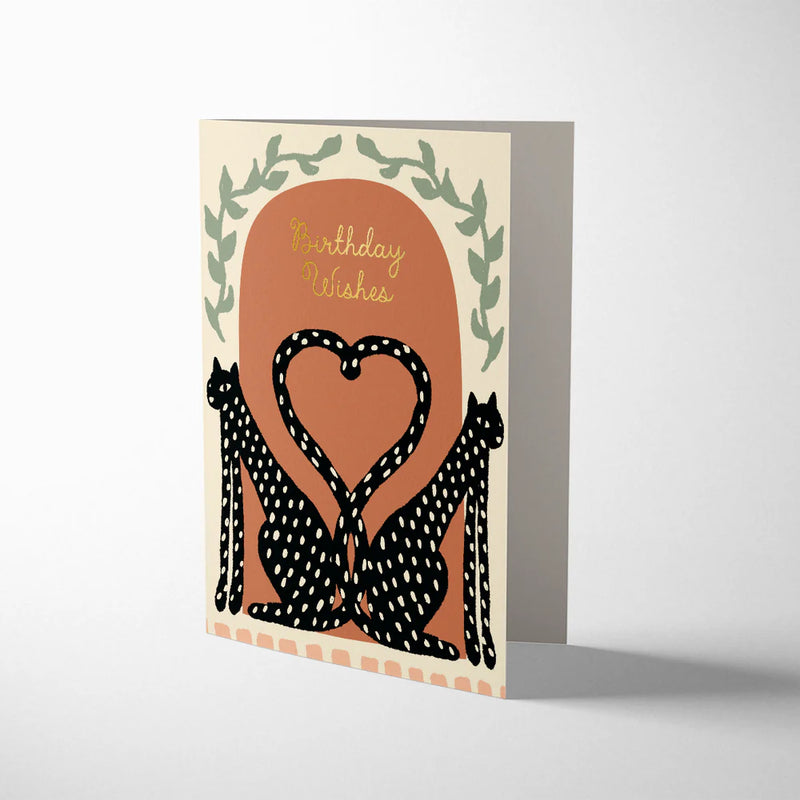 Greeting card with two leopards forming a heart and 'Birthday Wishes' text on a beige background.