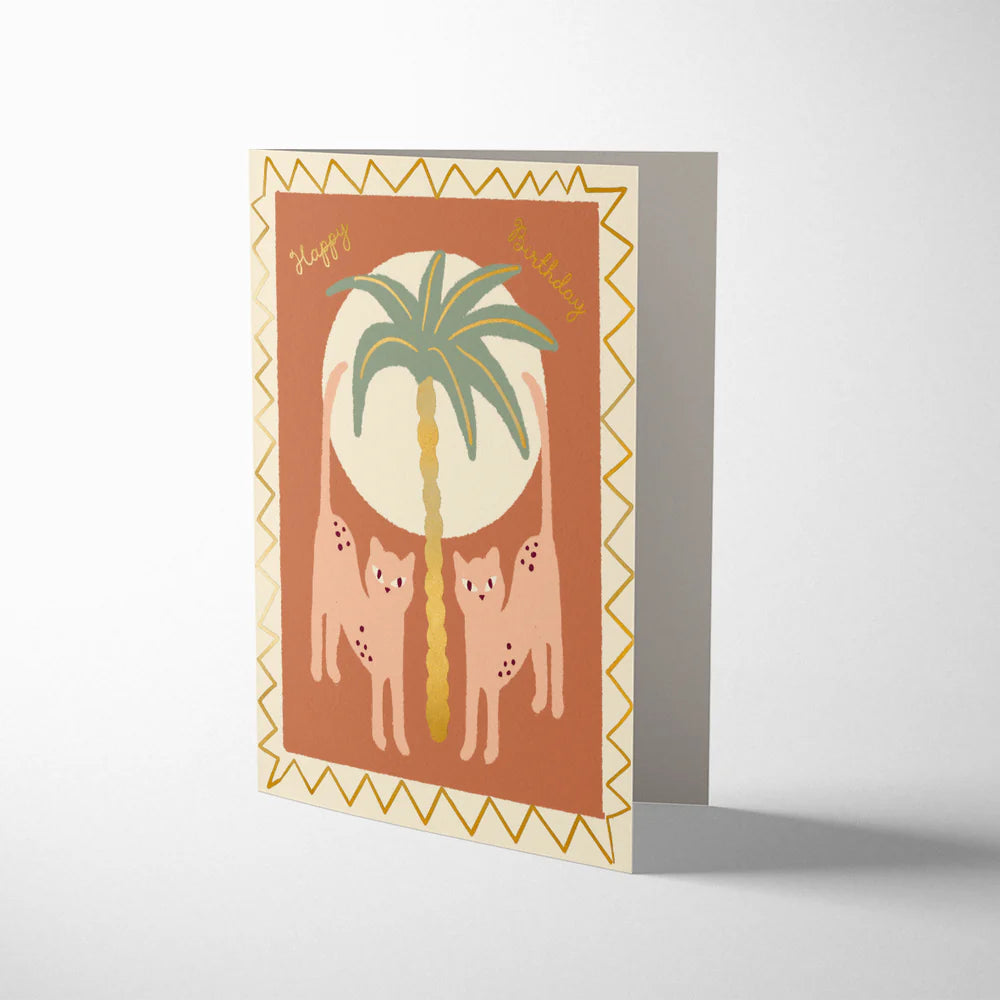 Greeting card with palm tree and cat design on a white background