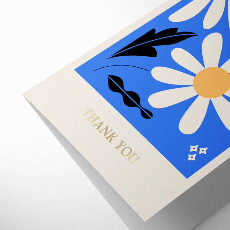 Greeting card with floral design and 'Thank You' text on a blue background