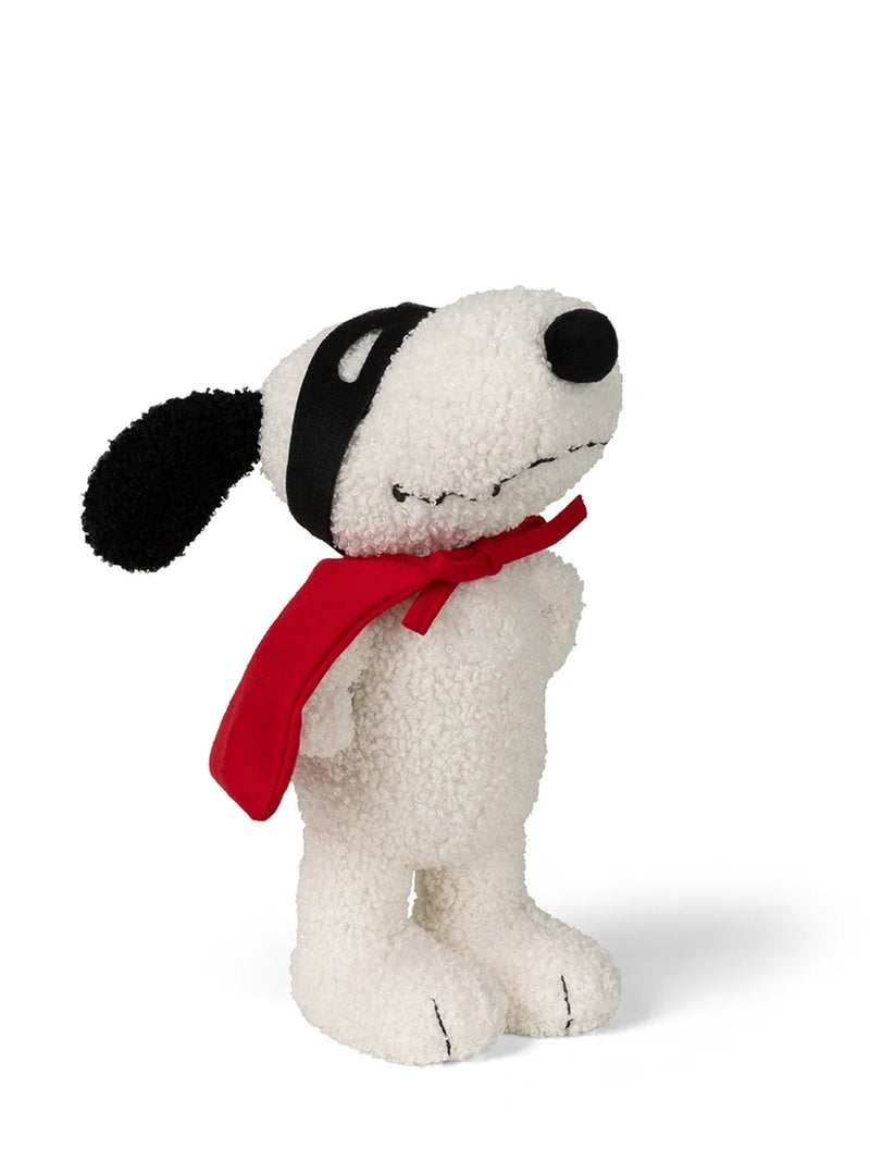 A plush dog toy styled like Snoopy, made from textured white bouclé fabric, wearing a black patch-over-ear headband and a bright red scarf, set against a plain white background.