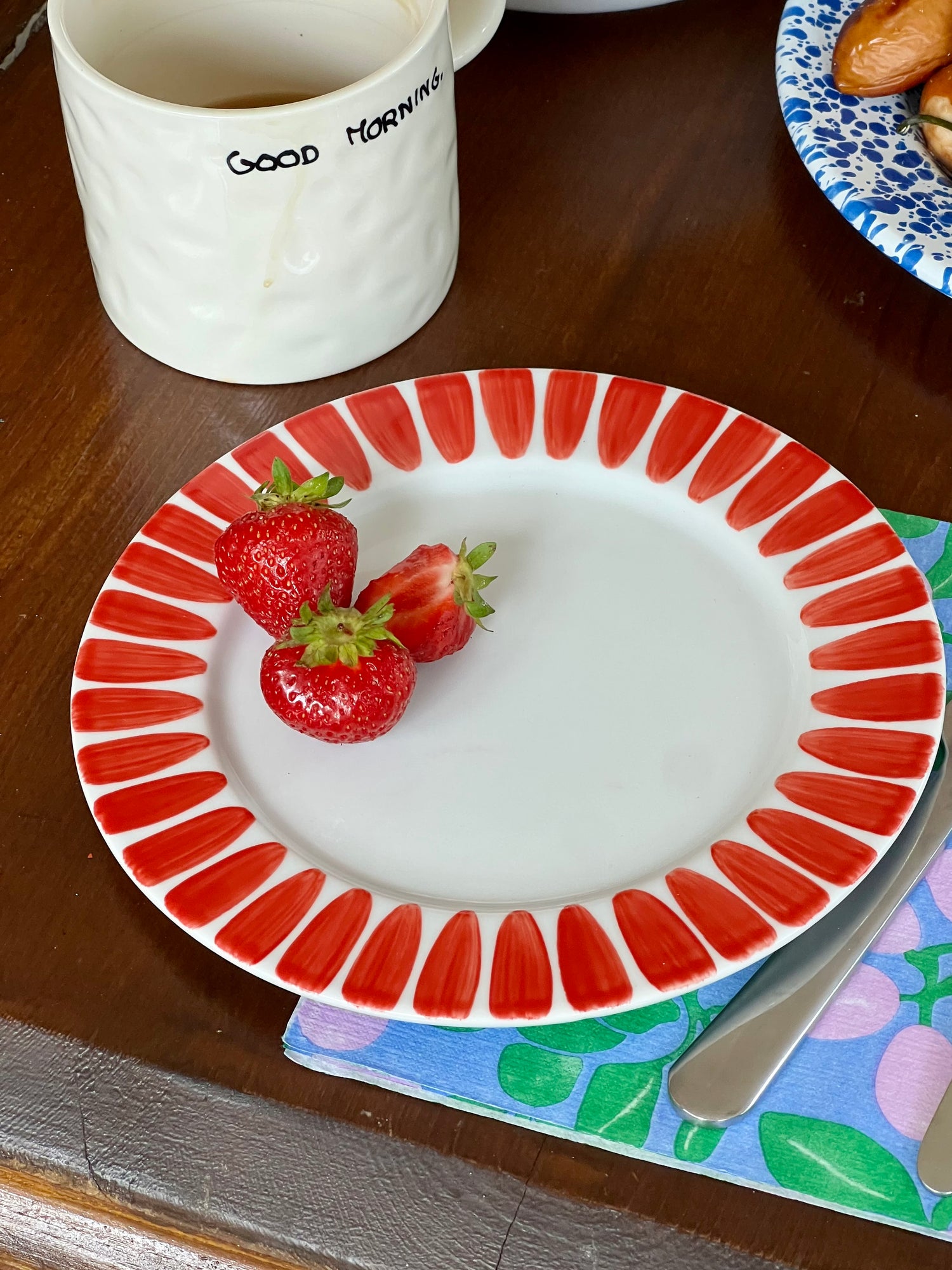 Red dessert plate with handpainted border