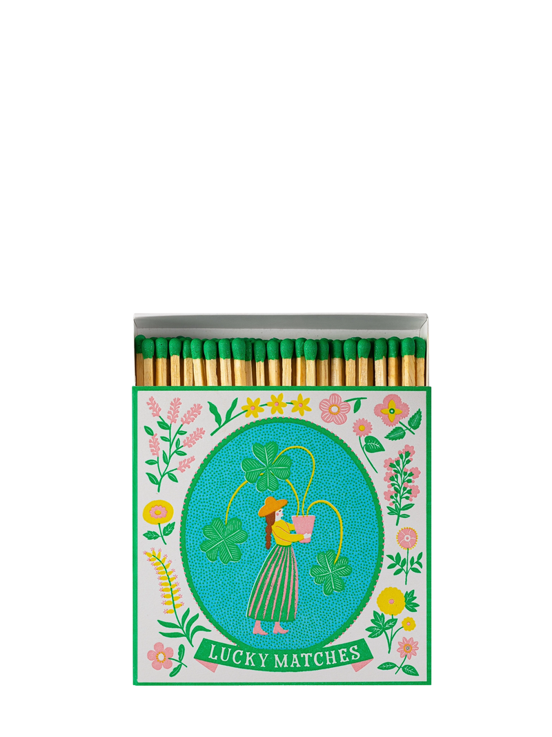 Matches with a decorative cover featuring a woman, flowers, and text on a white background