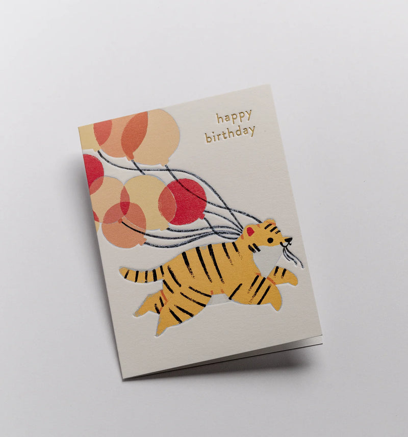 Birthday card with a tiger and balloons design on a white background